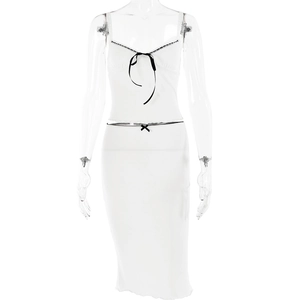 Detail view of white two-piece set with black bow accents and ribbon trim on mannequin
