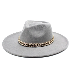 Detail of grey wool felt fedora featuring a decorative chunky gold metal chain link