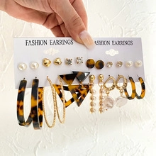 Macro view of 9-piece gold earring set featuring butterflies, pearls and tortoise resin