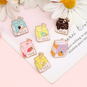 Set of colorful milk carton enamel pins in various flavors on a floral background