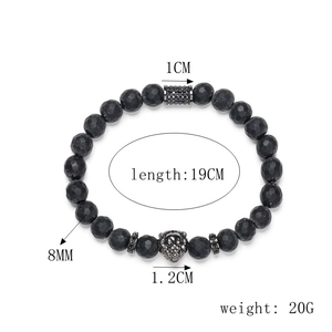 Macro shot of 8mm matte black faceted beads with a silver lion head and micro-inlaid spacers