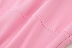Detailed macro view of pink fabric with double-needle stitching on the flare pants set