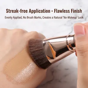 Angled foundation brush with synthetic bristles and rose gold ferrule for seamless finish