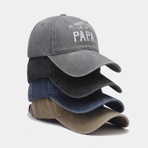 Pile of vintage washed cotton baseball caps in grey, black, navy and khaki colors