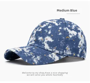 Detail view of medium blue washed denim baseball cap with gold star and moon embroidery