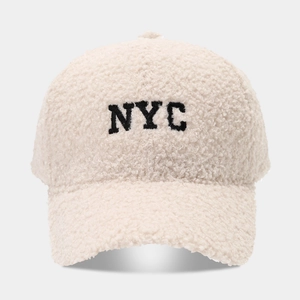 Creamy white NYC embroidered fleece baseball cap with warm lamb wool texture for winter