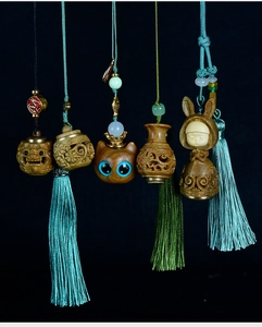 Exquisite handmade sandalwood pendants featuring lotus and zodiac rabbit with silk tassels