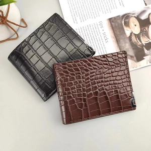 Detailed view of crocodile texture on men's bifold wallets in black and coffee colors
