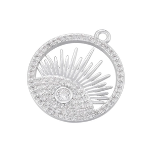 Detailed close-up of a silver sun-shaped pendant with evil eye motif and cubic zirconia