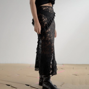Detailed close-up of a black lace maxi skirt with ruffled edges and sheer mesh texture