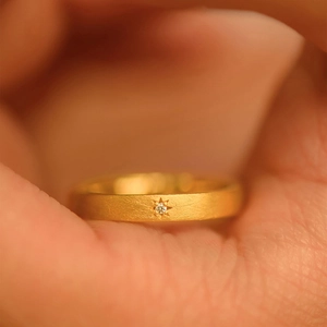 18k gold plated matte ring with starburst set zircon on a brushed metal band