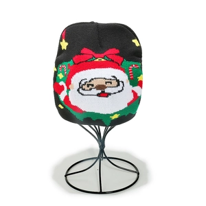 Detail of black knit beanie featuring a Santa Claus jacquard pattern for Christmas
