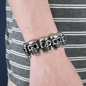 Men's punk style stainless steel skull link bracelet shown on a male wrist