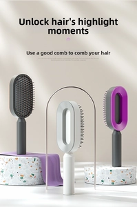 Detailed close-up of hollow oval massage hairbrushes on professional display stands
