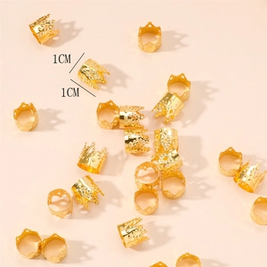 Detailed macro view of small 1cm golden metal crown charms for hair braid styling