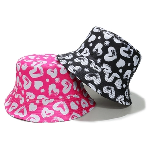 Japanese style cotton bucket hats with white heart patterns in pink and black colors