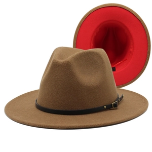 Detail of camel fedora hat with red interior, black leather band and gold buckle