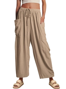 Detail view of khaki wide leg trousers with elastic drawstring waist and large cargo pockets
