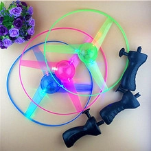 Detail of LED light-up flying saucer toy set with green pink and blue discs