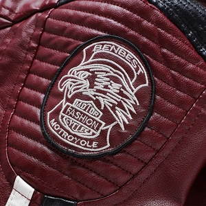 Men's burgundy motorcycle jacket with detailed embroidered patch and quilted leather finish