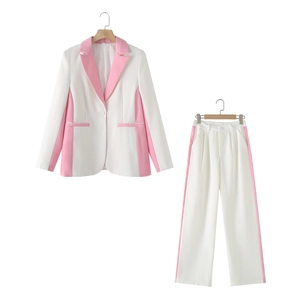 Modern two-piece women suit featuring a bold white and bright pink color-block design