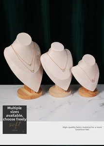 Three premium velvet necklace busts with beech wood bases on marble background