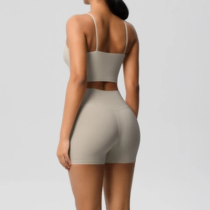 Detail view of the back of a beige ribbed yoga set with a sports bra and high-waisted shorts