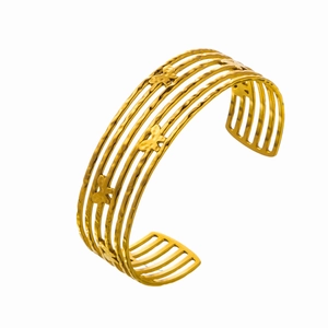Close-up of golden wavy cuff bracelet with intricate butterfly charms and textured finish