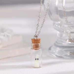 Macro shot of Halloween ghost necklace with miniature glass bottle pendant and cork stopper