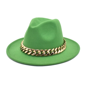 Detail of green wool fedora with a chunky gold chain strap on a white background