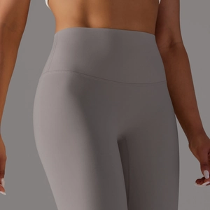 Detail of high-waisted seamless yoga leggings in charcoal grey with supportive compression