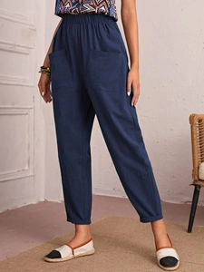 Detail view of navy blue cotton linen trousers with elastic waist and large front pockets