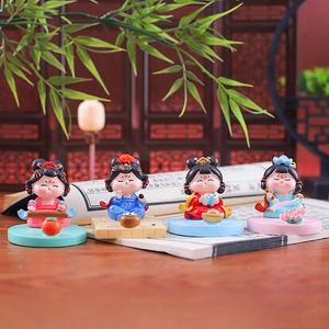 Four traditional Chinese art figurines representing Qin, Qi, Shu, and Hua on desks