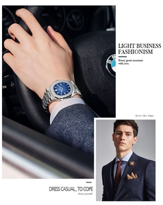 Detail of luxury men's business watch with blue dial while driving a premium car