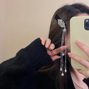 Silver metal hair clip with long tassel chains and pearls on female model side view