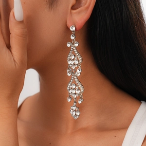 Close-up of sparkling rhinestone flower tassel earrings with long flowing silver-colored dangles