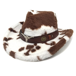 Plush cow print cowboy hat with western bull head metal accents on a brown band
