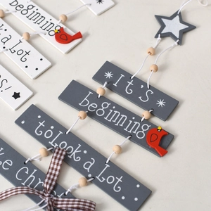 Rustic wood Christmas tree door hanging with red bird, stars and holiday lyrics