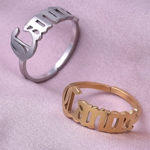 Macro shot of silver and gold Cancer zodiac rings on a soft purple silk background