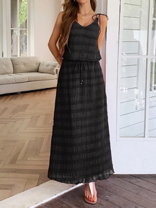 Detailed texture of black pleated two-piece resort set with drawstring skirt and crop top
