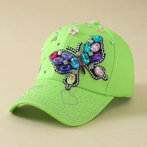 Macro view of colorful rhinestone butterfly decoration on neon green baseball cap