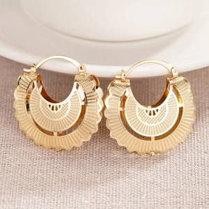 Golden hollow striped hoop earrings with intricate textured fan design in bohemian style