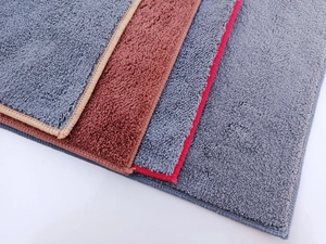 Close-up of double-layer coral fleece car towels showing thick microfiber texture and colors