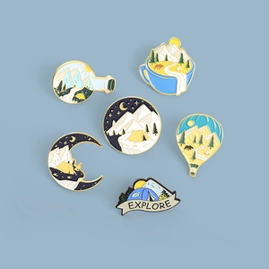 Detail view of 6-piece outdoor camping enamel pins featuring mountains and hot air balloons