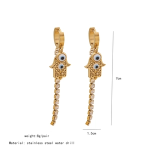 Detailed view of 7cm long Hamsa Hand tassel earrings with blue evil eye and rhinestones