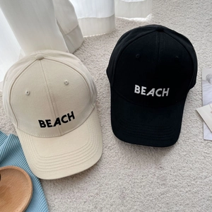 Classic cotton baseball caps in beige and black with BEACH embroidery and adjustable strap