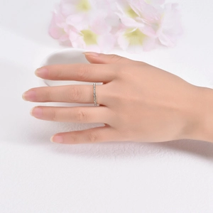 Elegant rose gold stainless steel ring with zircon stones shown on a model's hand
