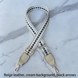 Adjustable wide canvas shoulder strap with black geometric arrows and gold metal hooks