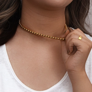 18K gold plated stainless steel round snake chain necklace worn by a female model