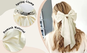 Detail of elegant cream bow hair clip with spring clamp and smooth damask fabric texture